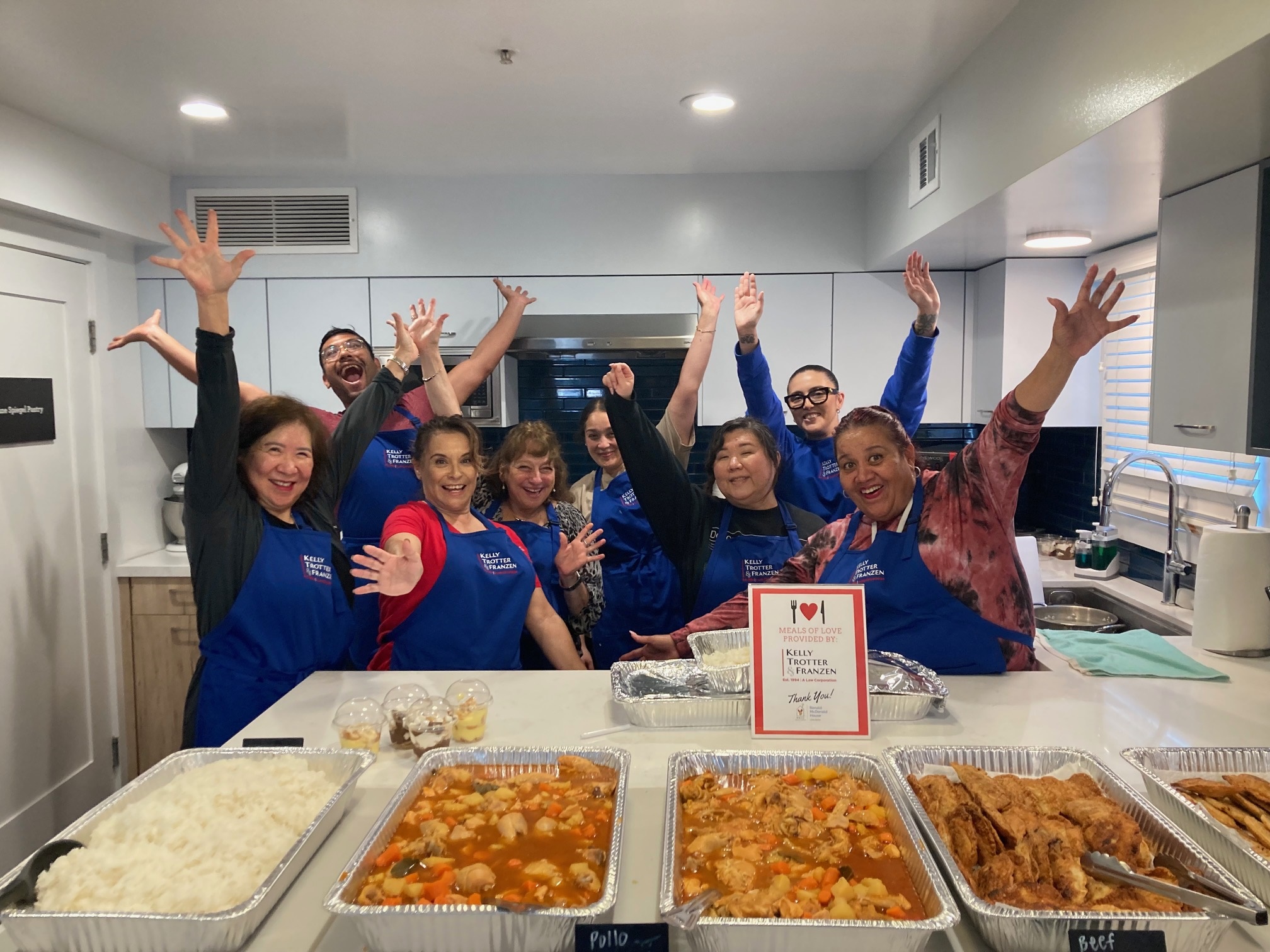 The Long Beach Ronald McDonald House - Volunteers with hands in the air photo number one.
